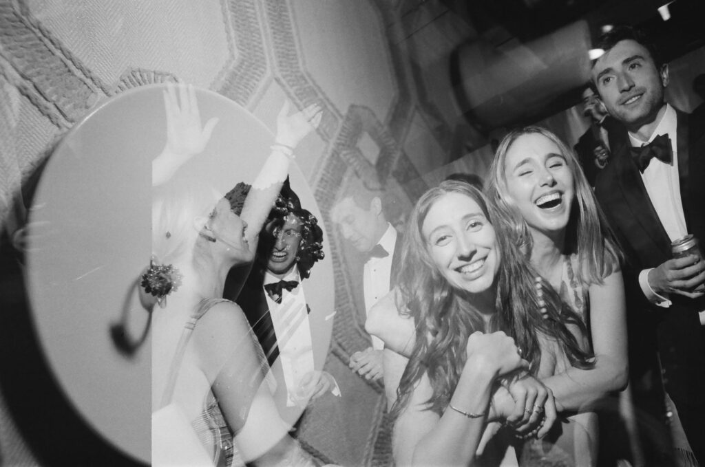 double exposure film photo of wedding guests smiling and laughing at little nell aspen wedding reception