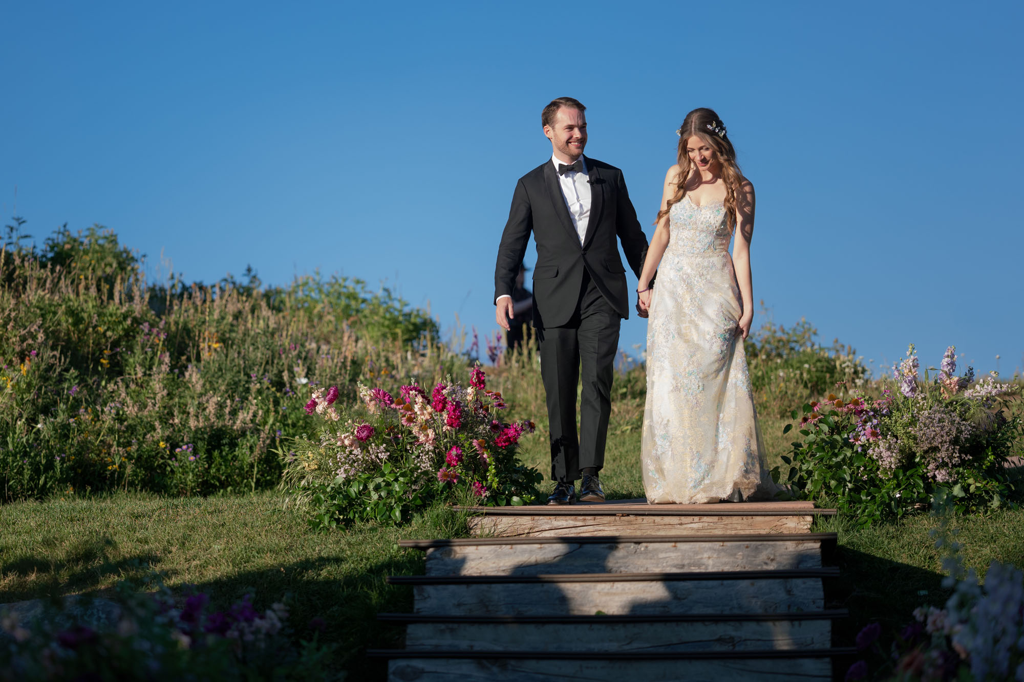 Bride and groom walking down steps at their Little Nell Wedding by Laura Stone