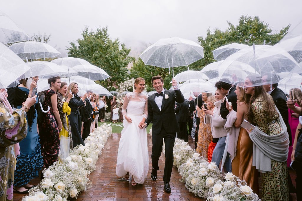 bride and groom walking down a red-bricked pathway after getting married at their hotel jerome aspen wedding