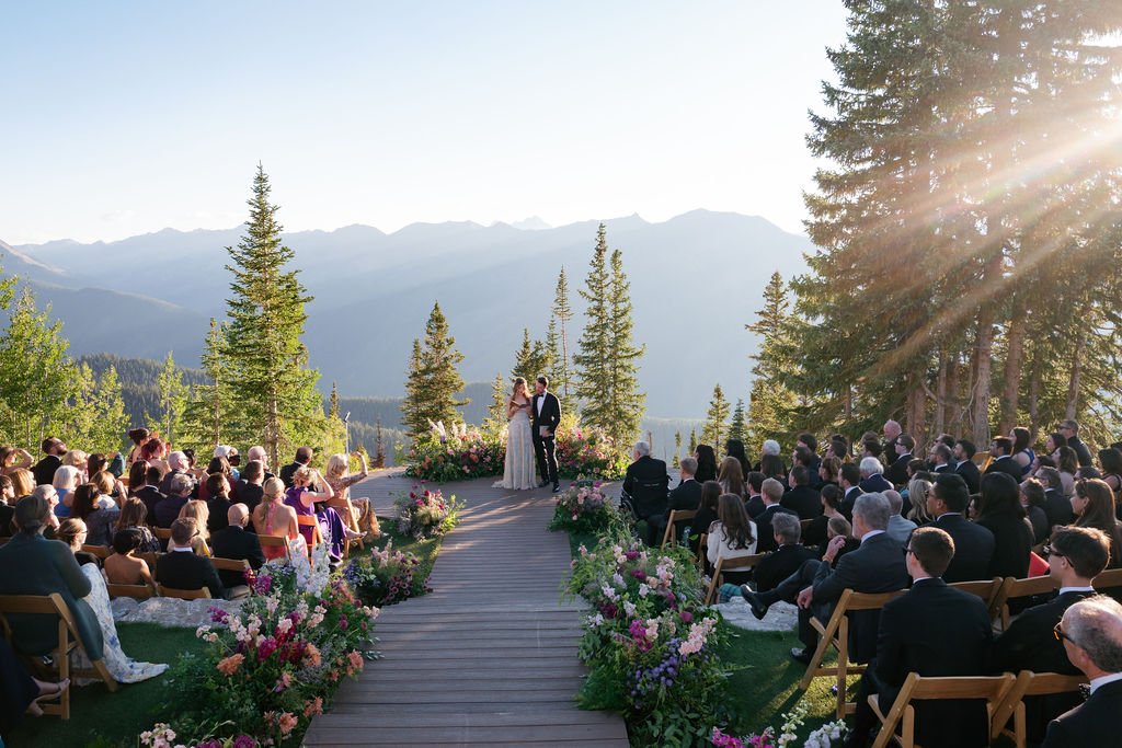 bride and groom during wedding ceremony at little nell, aspen mountain wedding venue