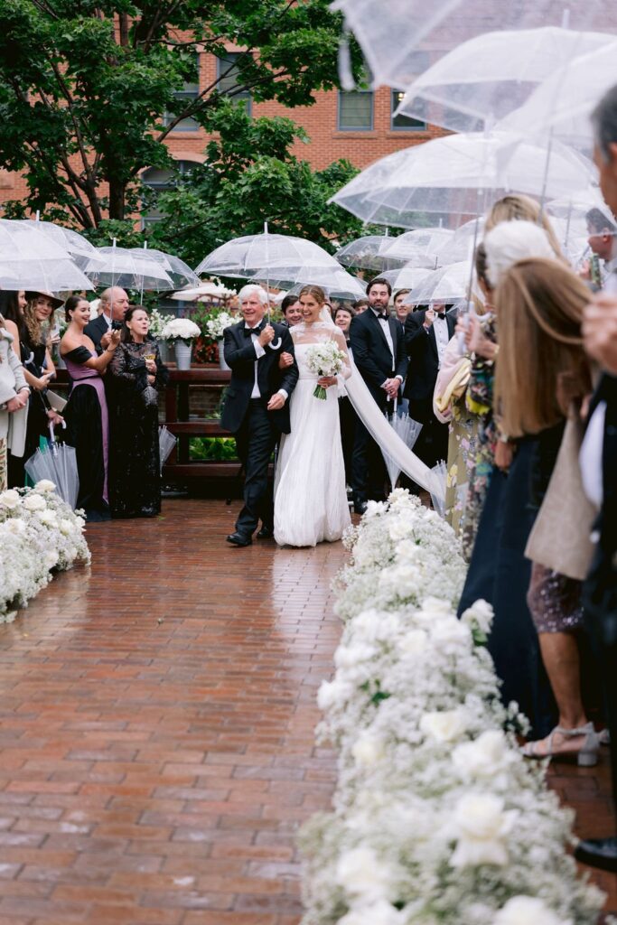 bride walking down the aisle during her ​jerome hotel aspen wedding ceremony