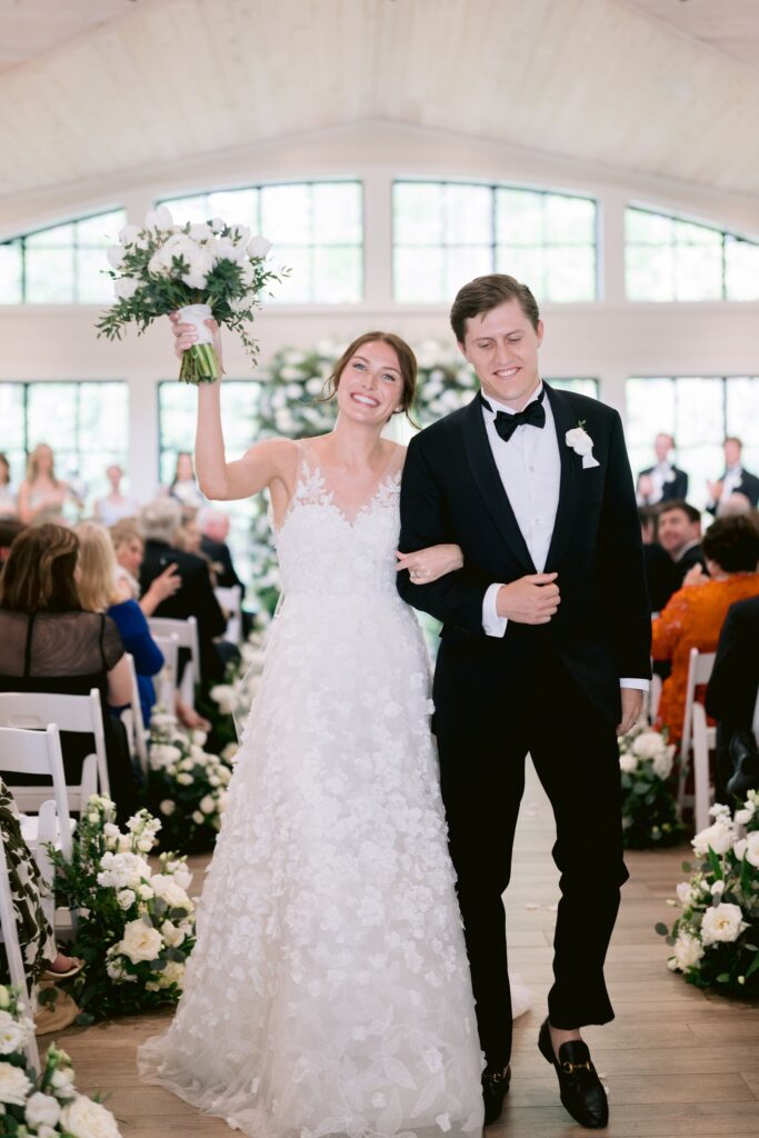 bride and groom walking down the aisle after getting married at their old edwards inn wedding venue