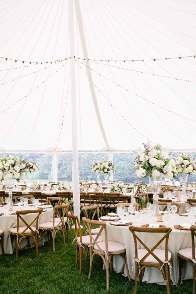 round tables stretched across the grass, layered with florals and soft textures at Piermont Cottage at Old Edwards Inn and Spa