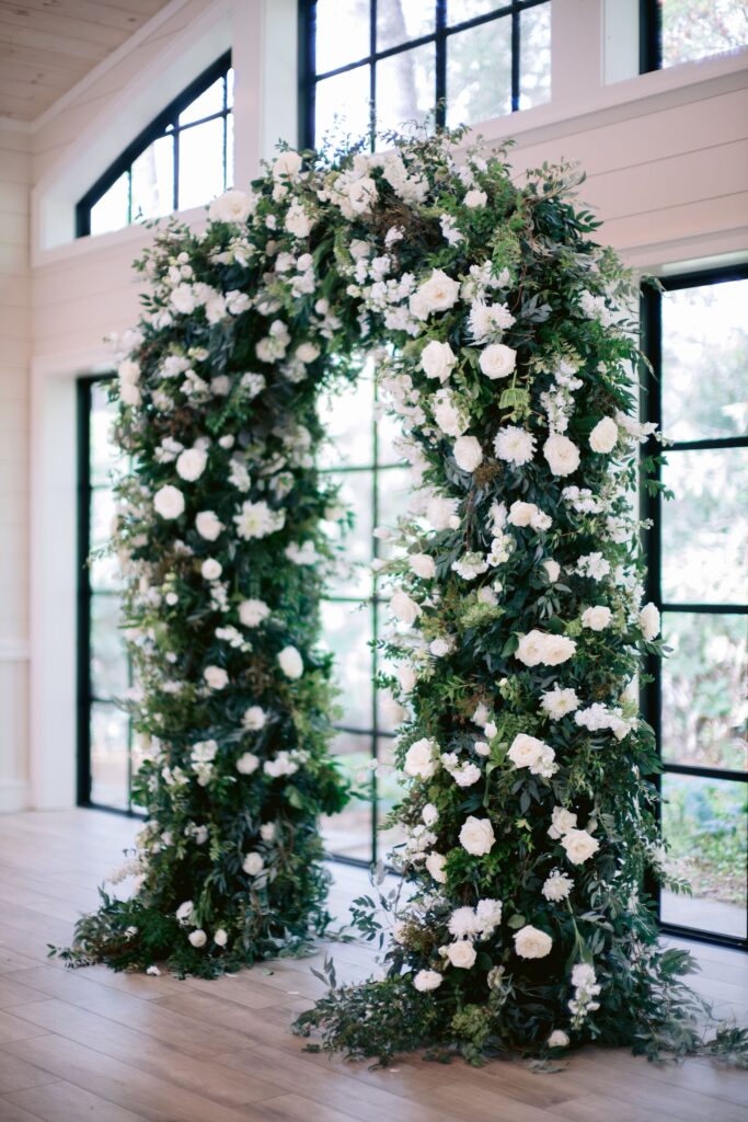 arch draped in greenery at an old edwards inn and spa wedding ceremony venue