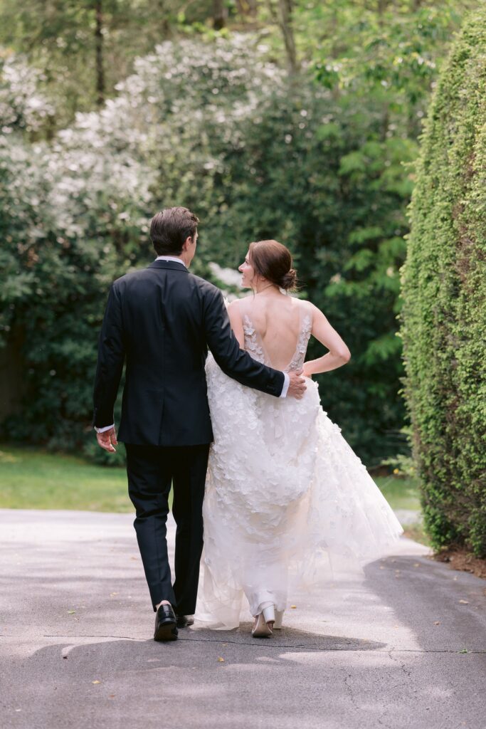 groom and bride walking while sharing an intimate moment during their portrait shoot at their old edwards inn wedding