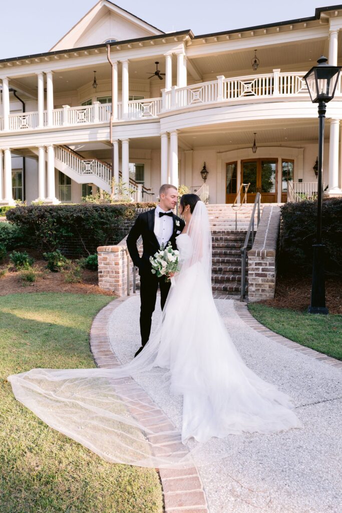 bride and groom lovingly looking at each other infront of their sea pines resort wedding reception venue