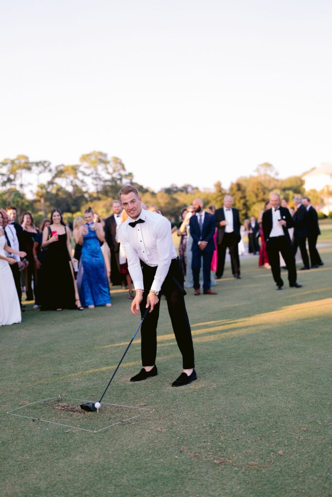 groom playing golf at sea pines resort during his sea pines wedding reception