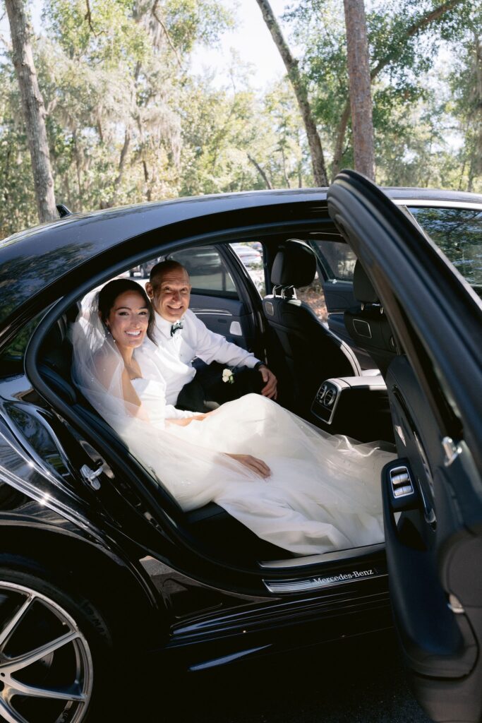 bride arriving in a black car at St. Francis by the Sea Catholic Church during her sea pines wedding