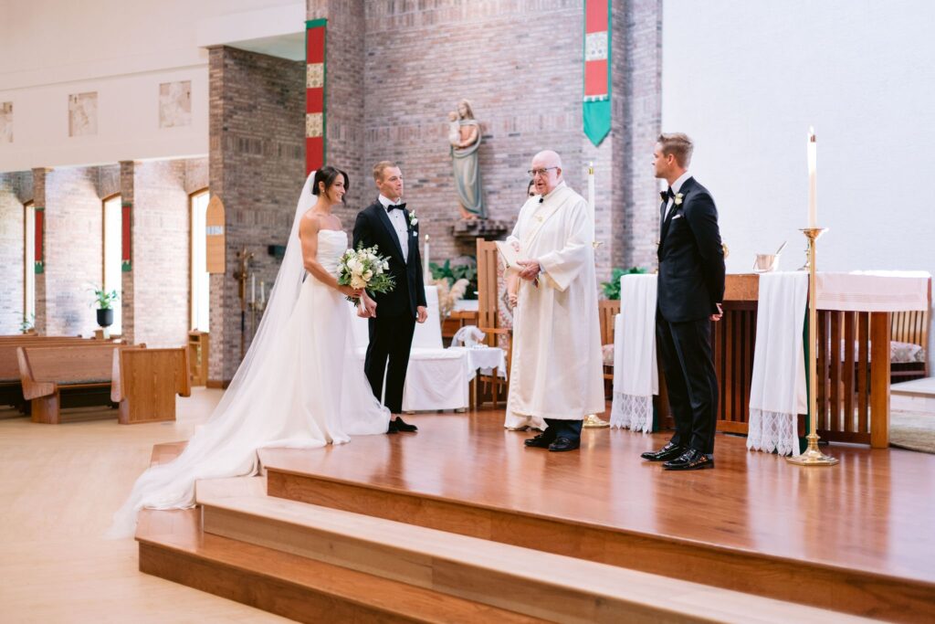 bride and groom standing at the alter in St. Francis by the Sea Catholic Church during their sea pines wedding