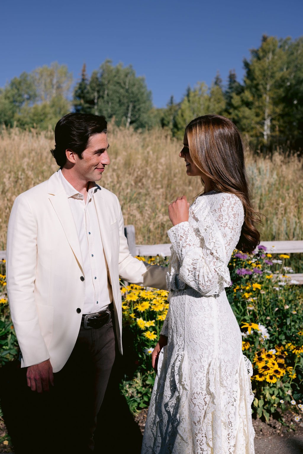 bride and groom smiling at each other during their aspen meadows wedding portrait session