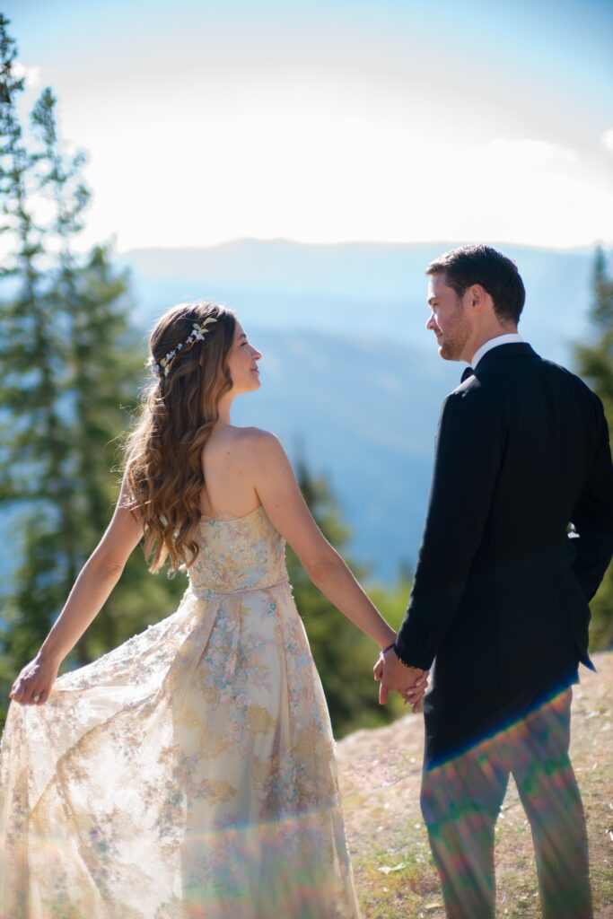 bride and groom holding hands during a luxury wedding in Aspen with mountain views and alpine trees