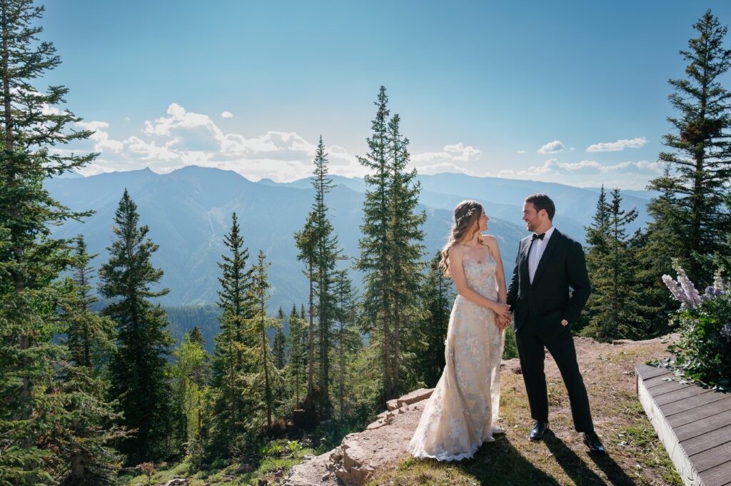 bride and groom posing on Aspen Mountain during an Aspen luxury wedding with stunning Colorado backdrops