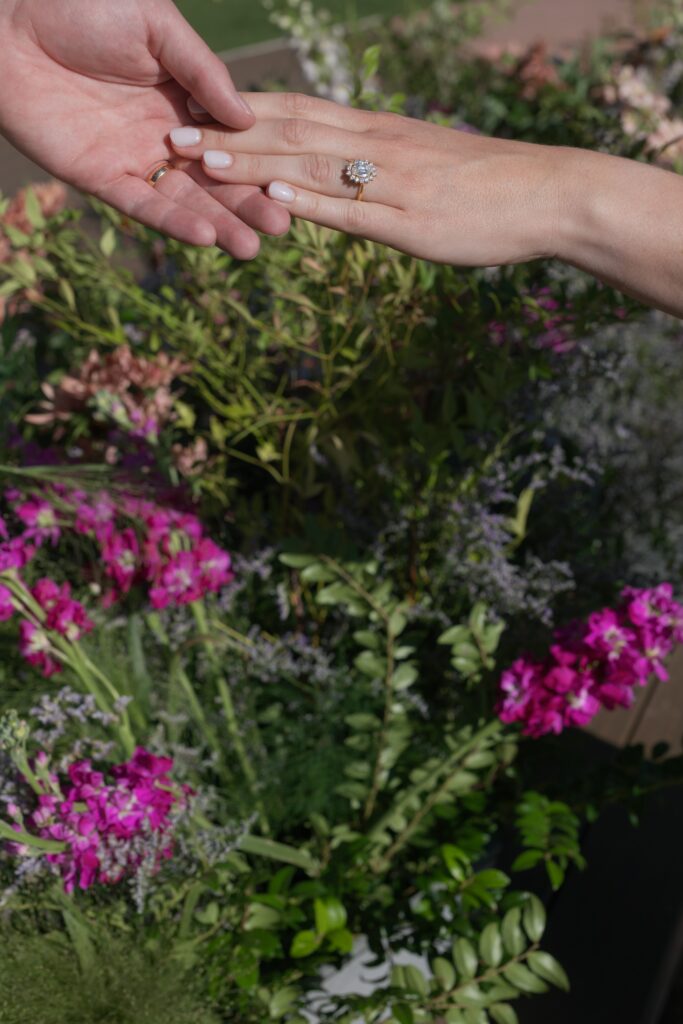 wedding rings during an Aspen wedding ceremony surrounded by colorful florals and mountain-inspired design