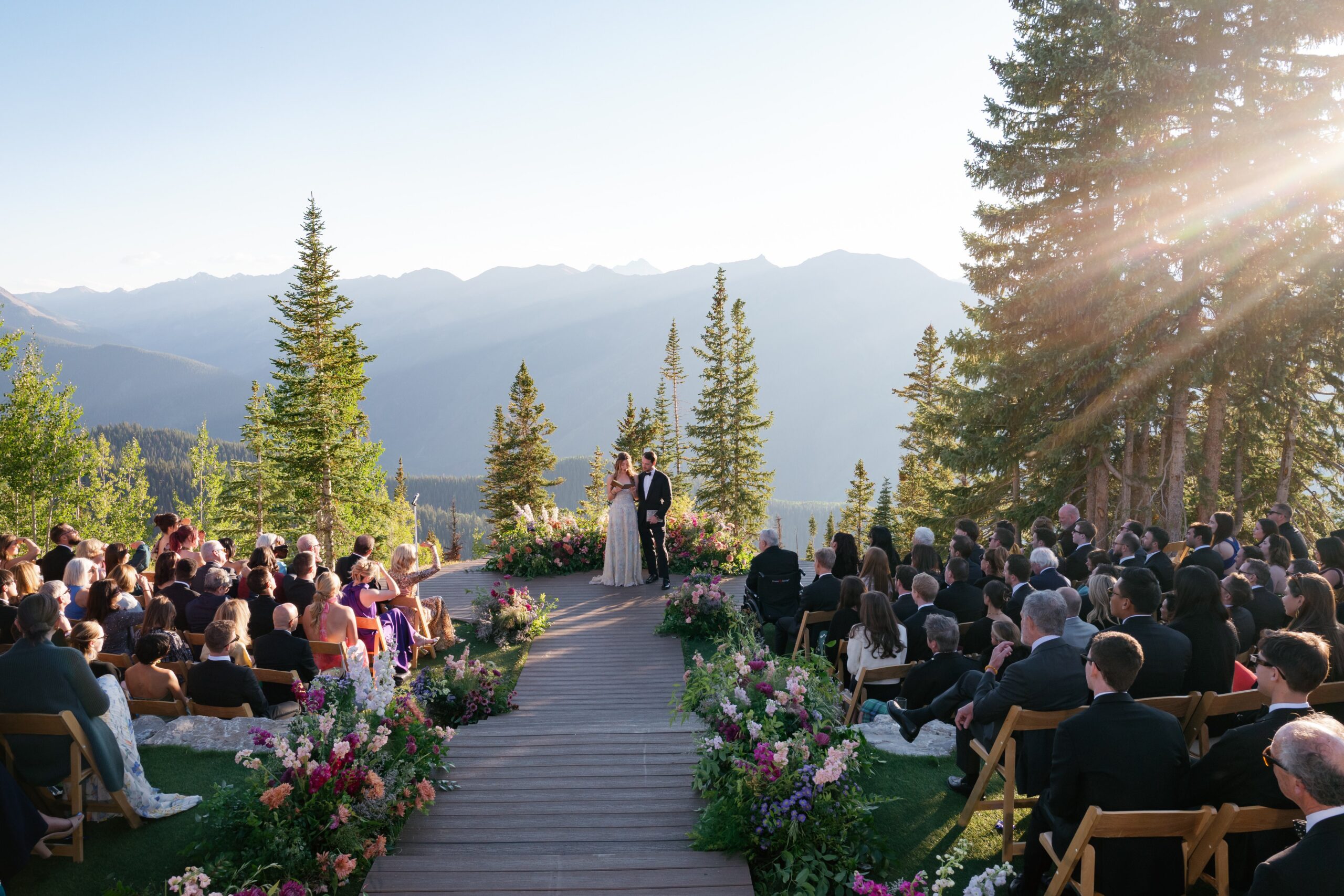 wedding ceremony at an Aspen mountain wedding venue with stunning backdrops and guests gathered for a luxury wedding in Aspen, Colorado