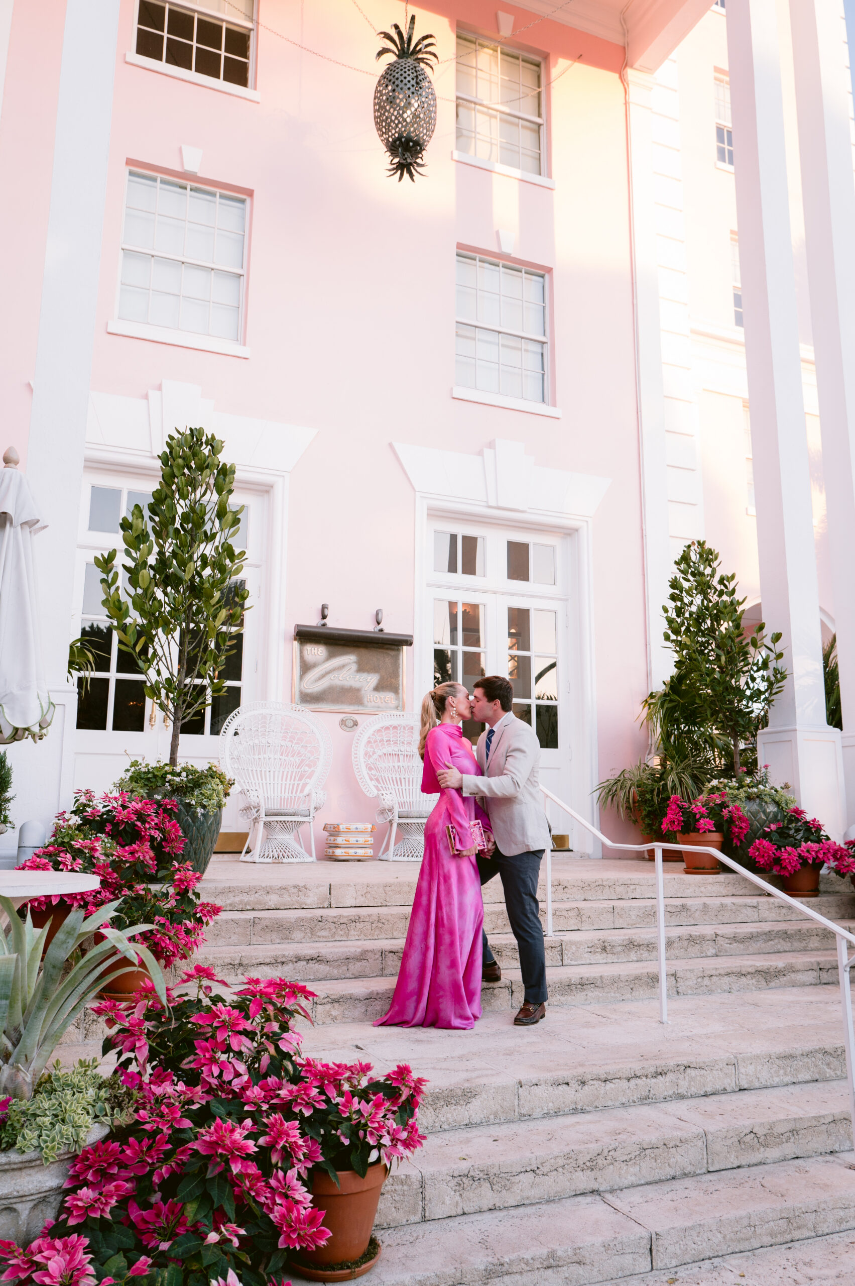 bride and groom sharing a kiss on the steps of one of the most iconic palm beach event venues, the colony hotel