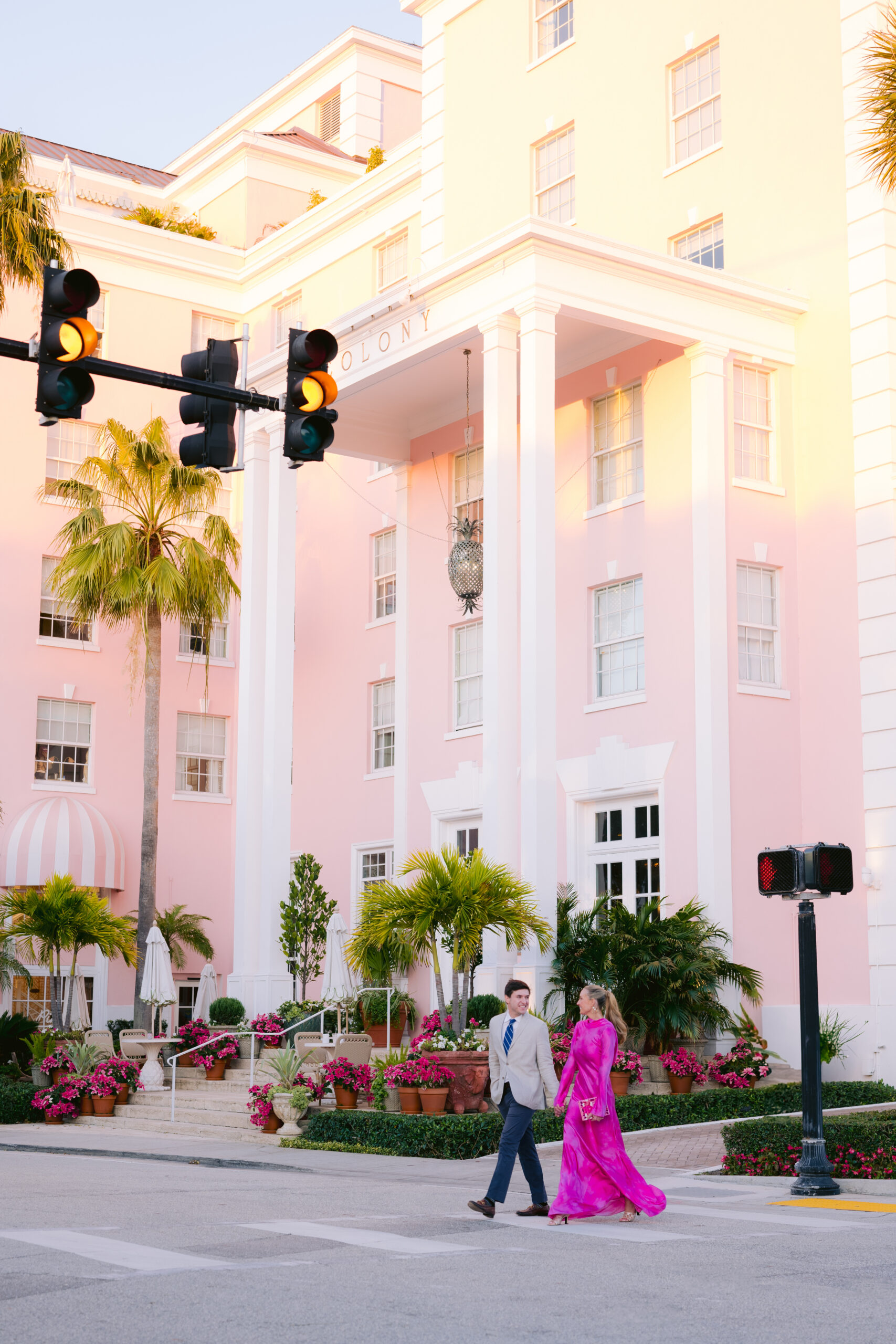 bride and groom walking  in front of the colony hotel and event venue in palm beach, fl