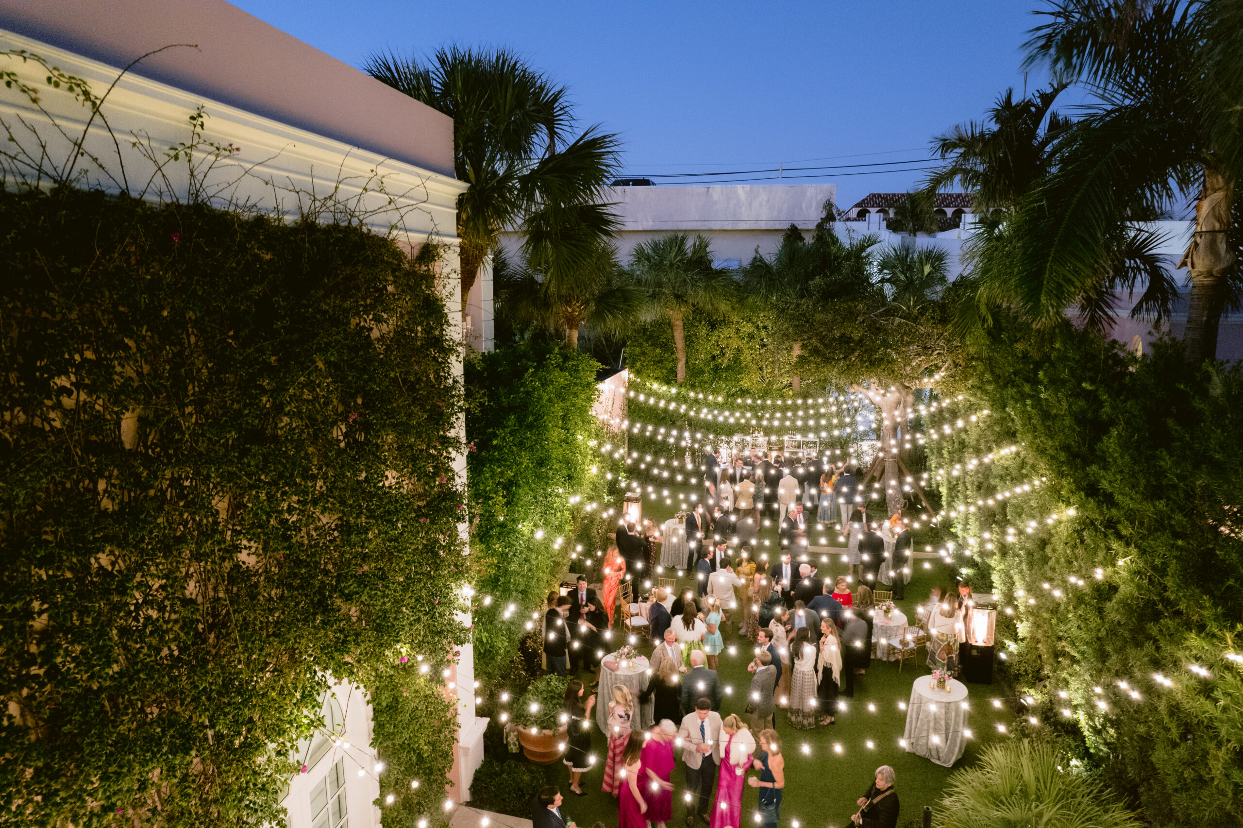 aerial shot of the colony hotel, palm beach, outdoor pool area where wedding guests are mingling
