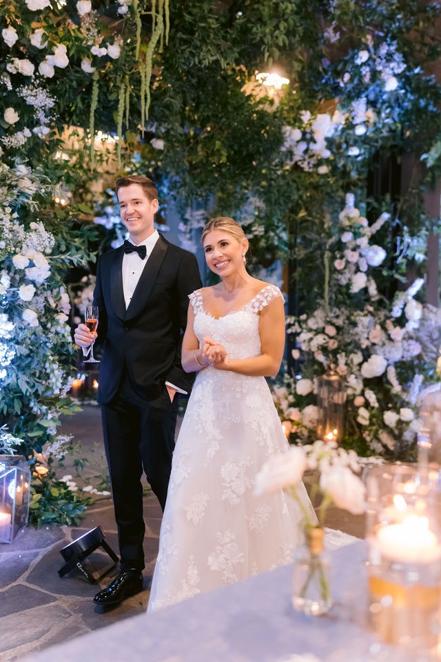 bride and groom entering their highlands nc wedding venue reception space