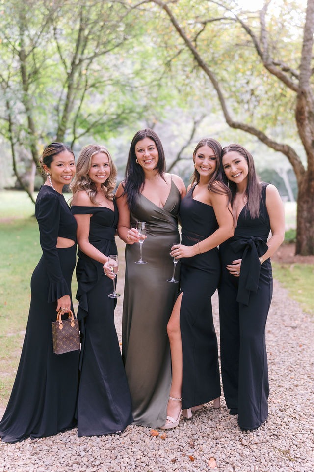 wedding guests posing for a photo at half-mile farm during a wedding celebration