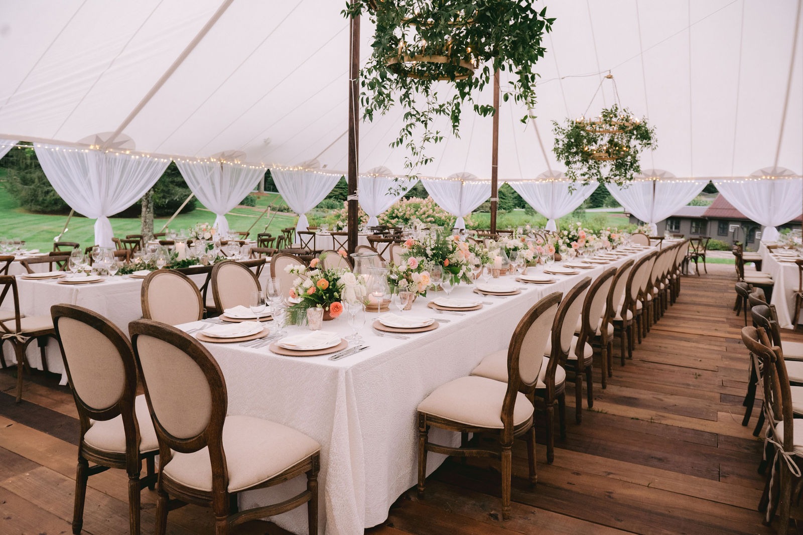 long table setup in a white tent for a wedding reception at one of the best wedding venues in highlands nc
