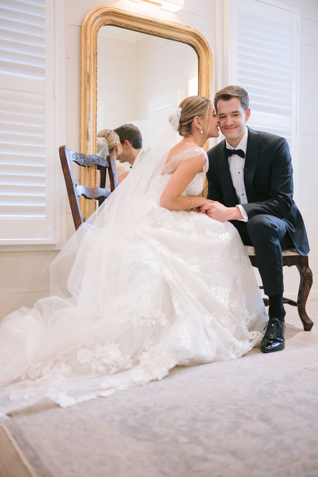 bride and groom whisperign sweet nothings while alone at their highlands nc wedding venue