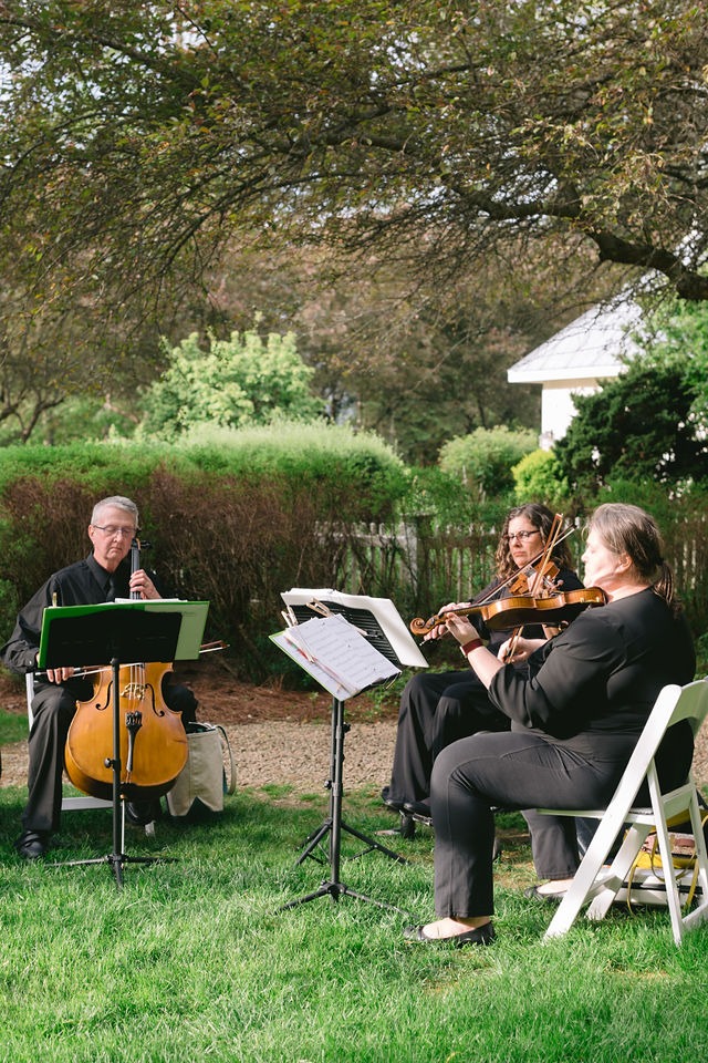 live band playing on the lawn of a highlands nc wedding venue during cocktail hour