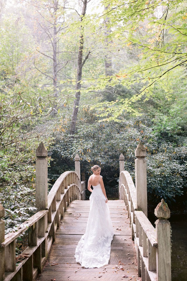 portrait of a bride on a wooden bridge at one of the best wedding venues in highlands, nc