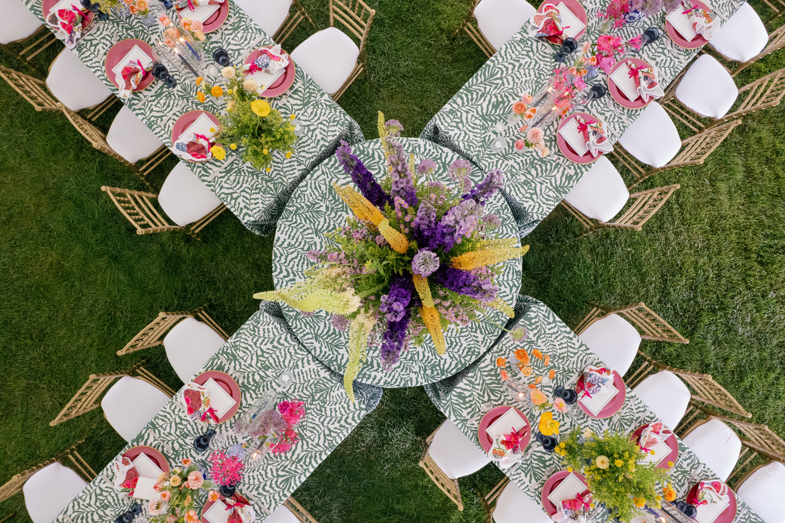 colorful X-shaped table setup for a wedding at half mile farm old edwards inn. designed by Floressence Flowers