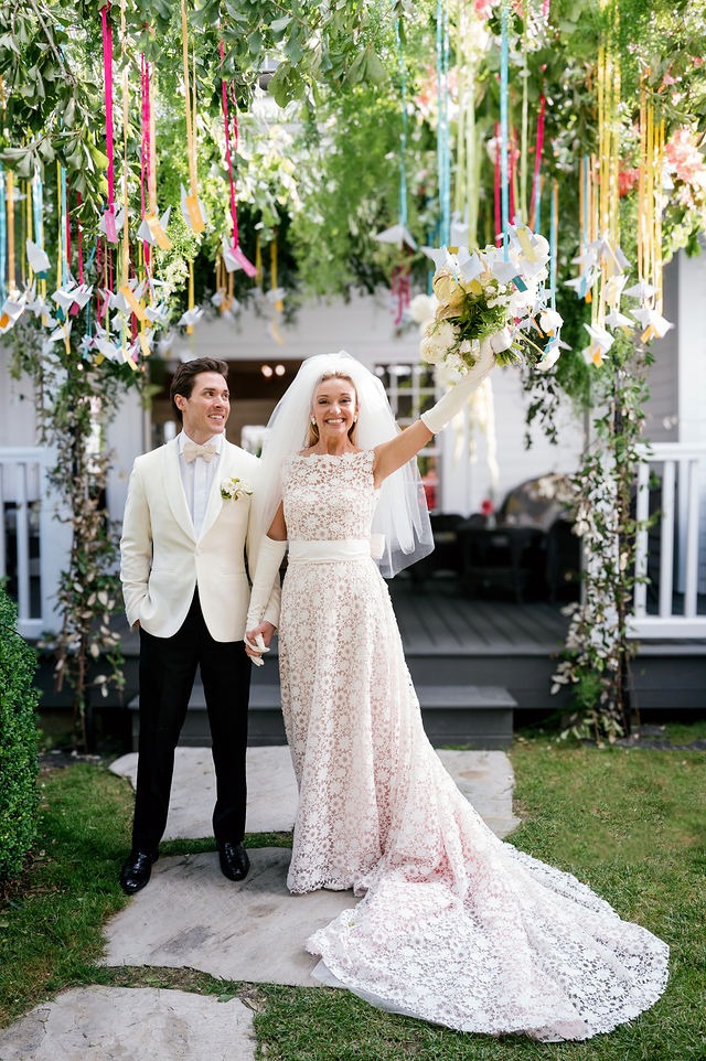 portrait of a bride and groom entering their wedding reception space at half mile farm old edwards