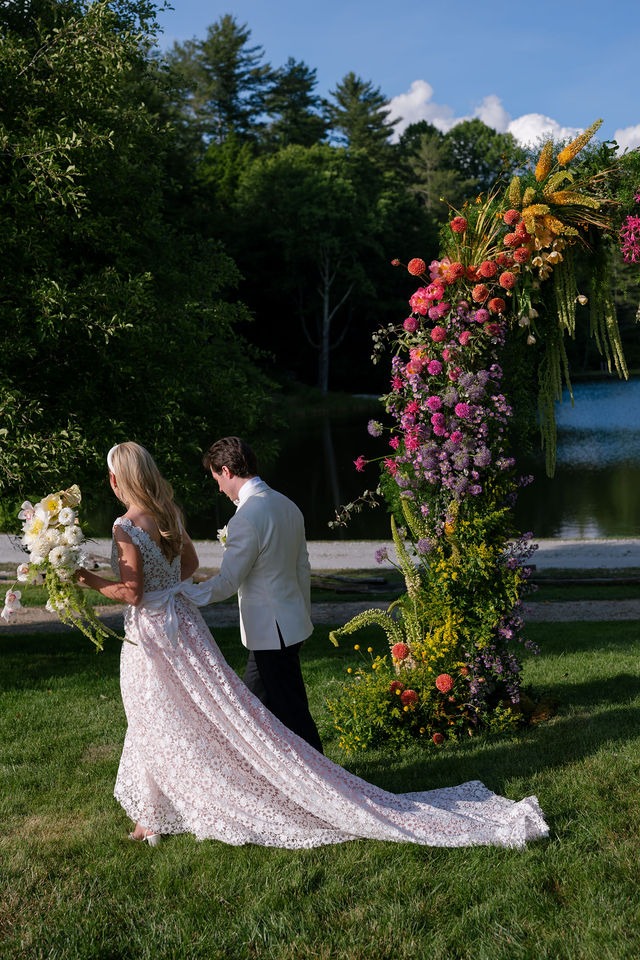 photograph of a bride and groom walking away from their half mile farm old edwards in ceremony space