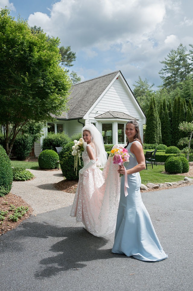 candid photo of a bride and one of her bridesmaids during her wedding at half mile farm north carolina