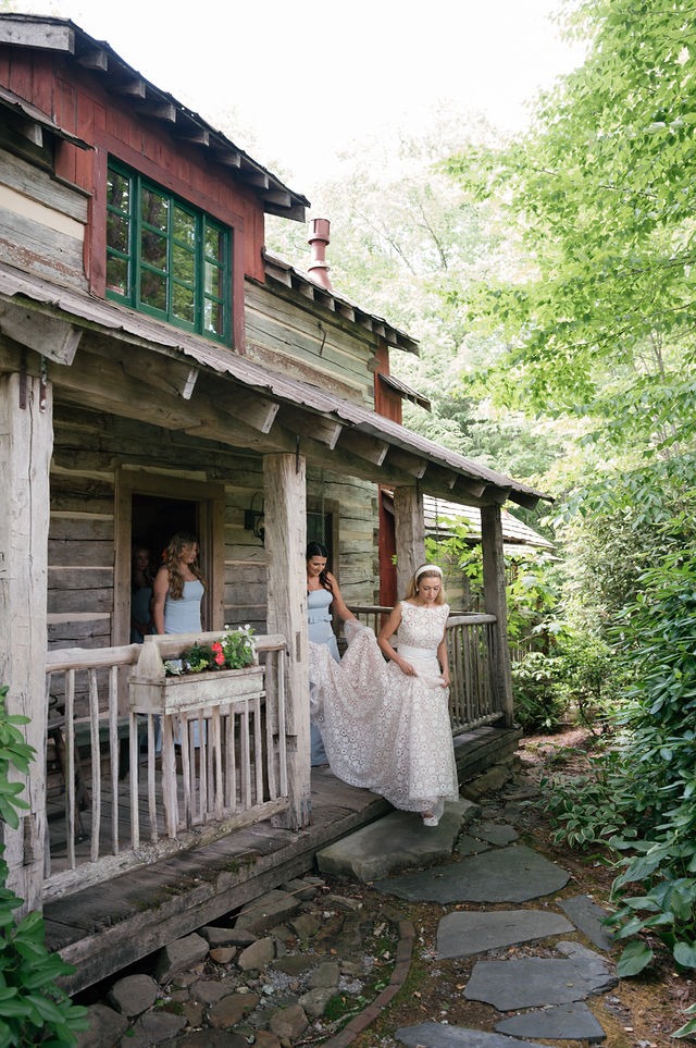 bride walking from her getting-ready suite with her bridesmaids during her wedding day at half mile farm north carolina